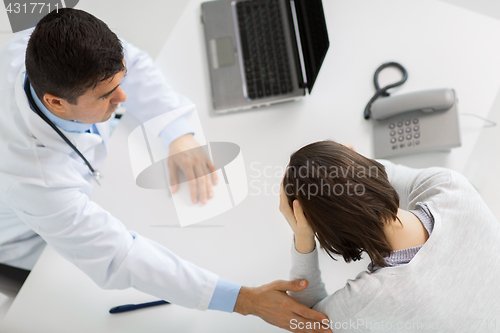 Image of doctor with laptop and woman patient at hospital