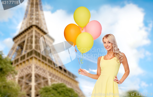 Image of happy woman in dress with helium air balloons