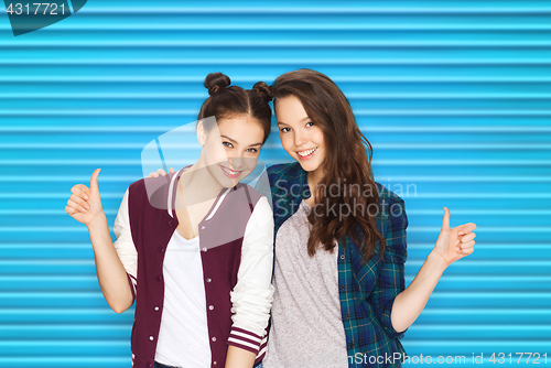 Image of happy smiling teenage girls showing thumbs up