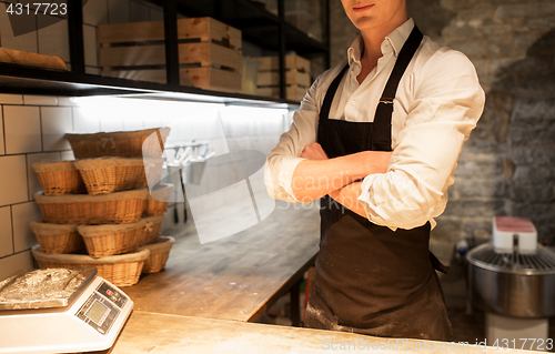 Image of chef or baker in apron at bakery kitchen