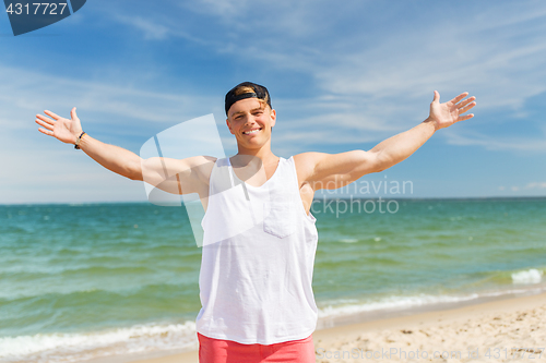 Image of smiling young man on summer beach