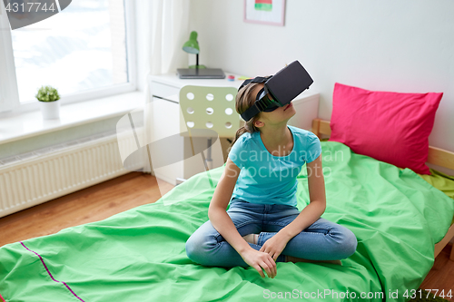 Image of happy girl in vr headset or 3d glasses at home