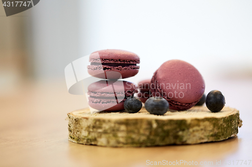 Image of blueberry macarons on wooden stand