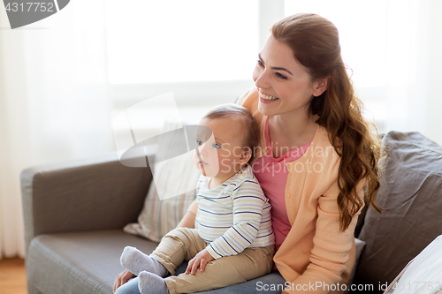 Image of happy young mother with little baby at home