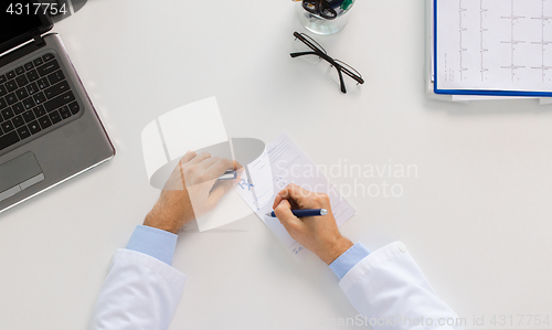 Image of doctor hands with prescription at clinic