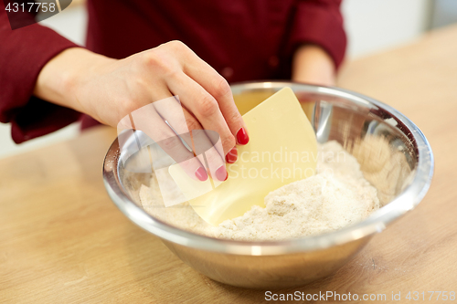 Image of chef with flour in bowl making batter or dough