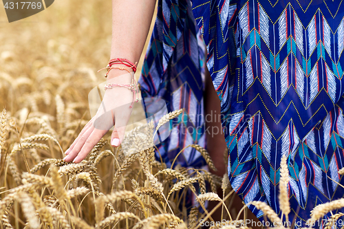 Image of close up of young hippie woman on cereal field