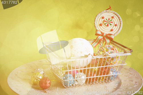 Image of Christmas balls in shopping basket, retro toned