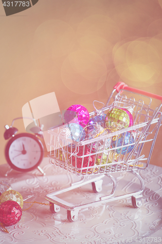Image of Christmas decorations in shopping trolley, retro toned