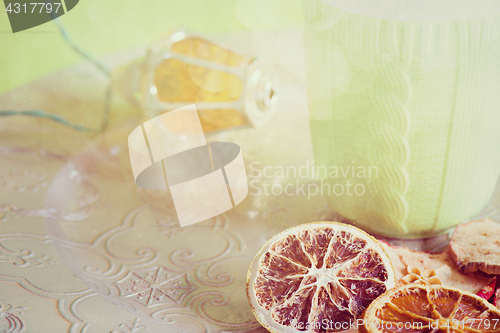 Image of Cup, christmas light bulb and cuted fruits, retro toned