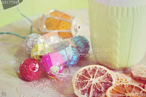 Image of Cup, christmas balls and cuted fruits, retro toned