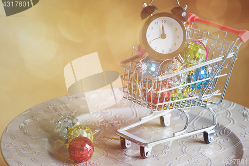 Image of Christmas decorations in shopping trolley, retro toned