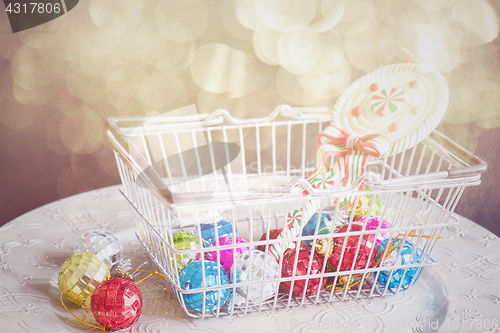 Image of Christmas toys in shopping basket, retro toned