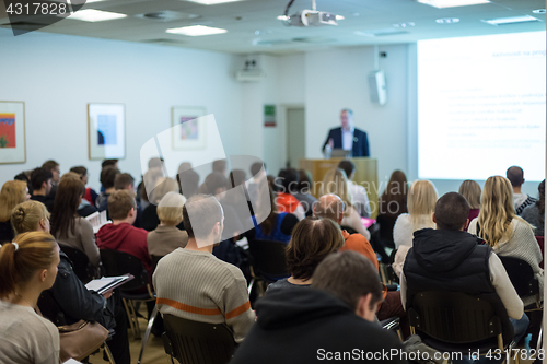 Image of Man giving presentation in lecture hall at university.