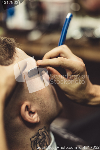 Image of Crop stylist shaving client