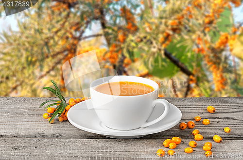 Image of Tea of seabuckthorn berries on wooden table