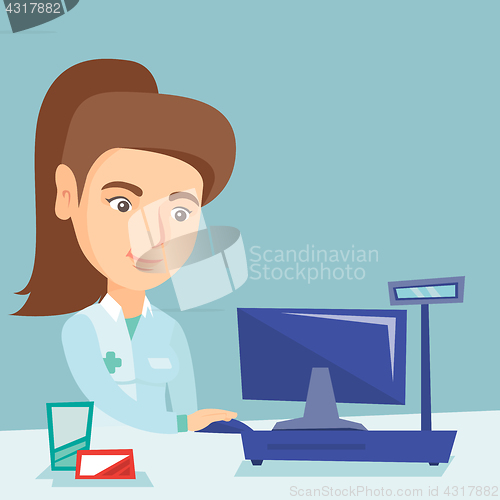 Image of Pharmacist working on a computer in a drugstore.