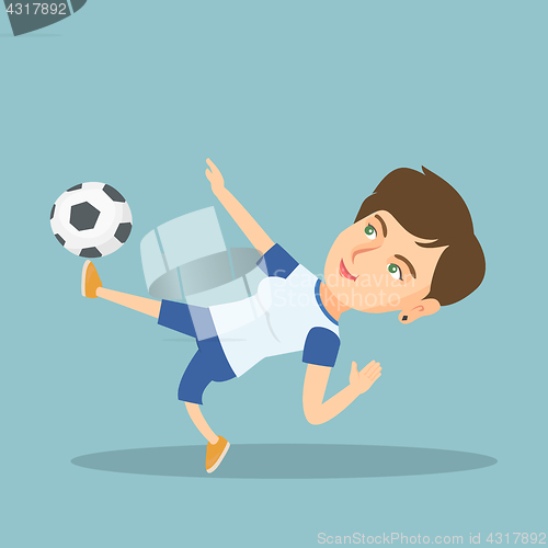 Image of Young caucasian soccer player kicking a ball.