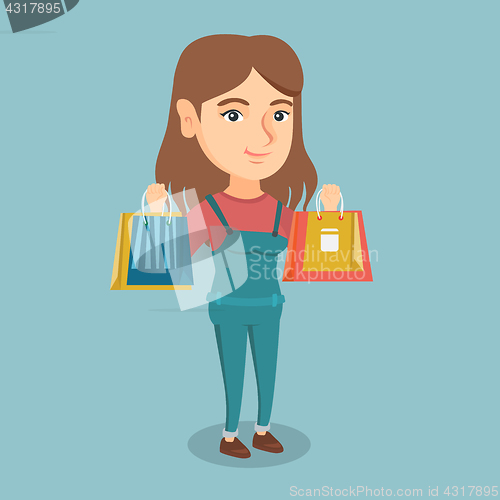 Image of Young caucasian woman holding shopping bags.