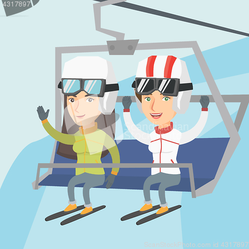 Image of Two caucasian skiers using cableway at ski resort.