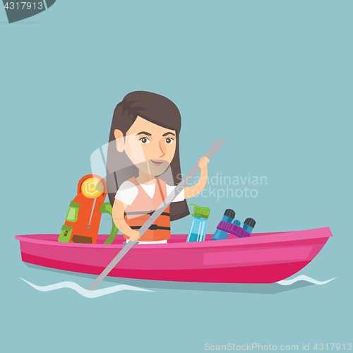Image of Young caucasian woman riding a kayak.