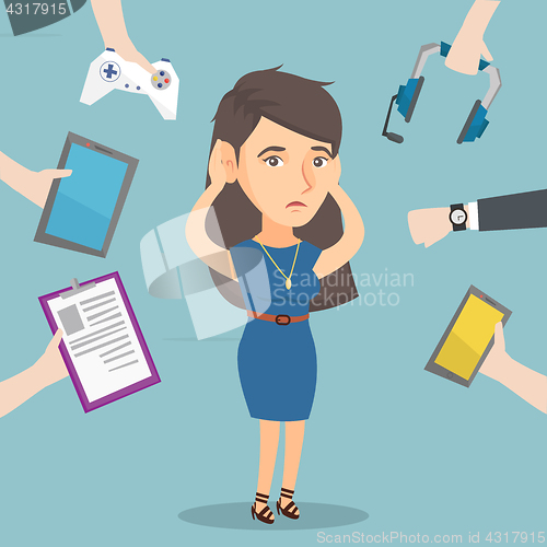 Image of Young caucasian woman surrounded by her gadgets.
