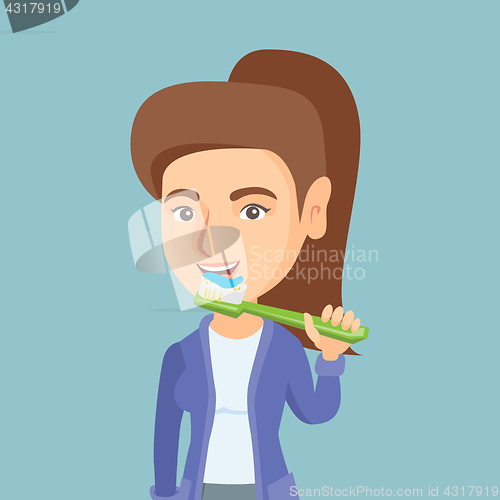 Image of Young caucasian woman brushing her teeth.