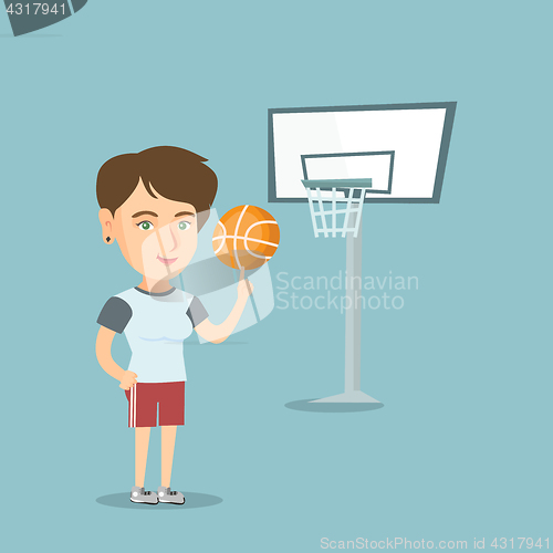Image of Young caucasian basketball player spinning a ball.
