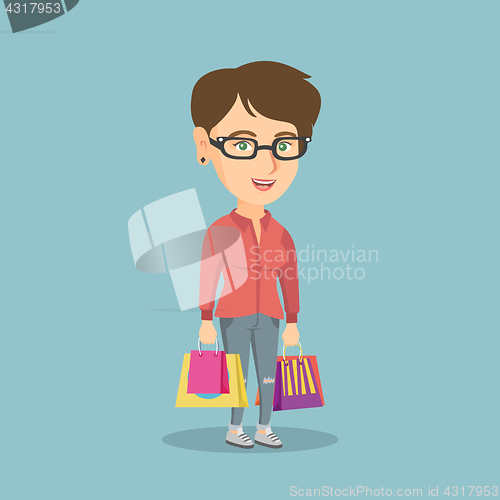 Image of Young happy caucasian woman with shopping bags.