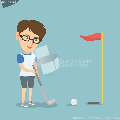 Image of Young caucasian golfer hitting a ball.