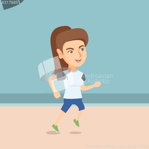 Image of Young sporty woman jogging on the beach.