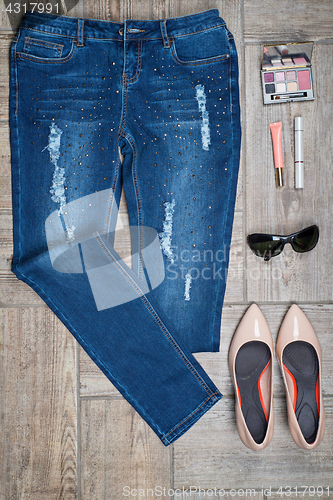 Image of Aerial view of woman\'s jeans and accessories