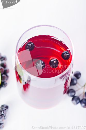 Image of Glass of aronia juice with berries