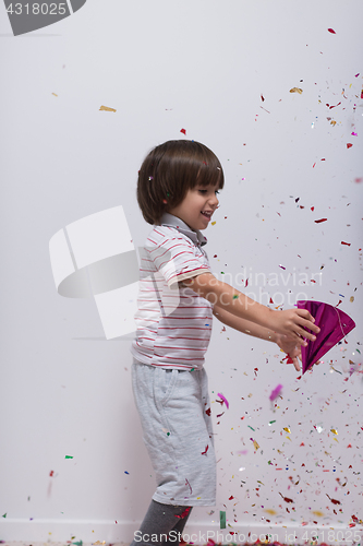 Image of kid blowing confetti