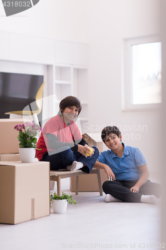 Image of boys with cardboard boxes around them