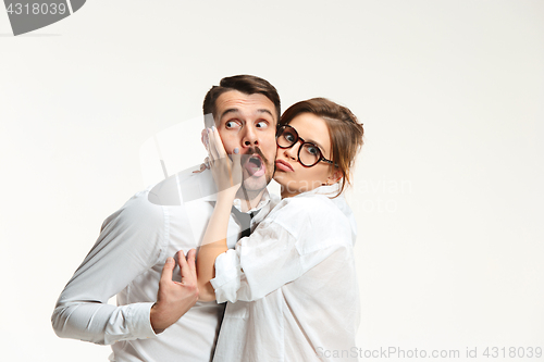 Image of The business man and woman communicating on a gray background