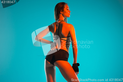 Image of Muscular young woman athlete posing at studio