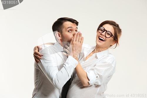 Image of The business man and woman communicating on a gray background