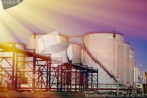 Image of Industrial zone, Steel pipelines and tanks against blue sky