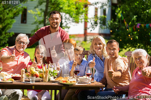 Image of happy family having dinner or summer garden party