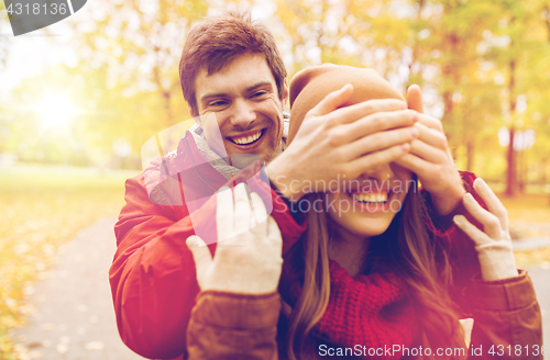 Image of happy young couple having fun in autumn park