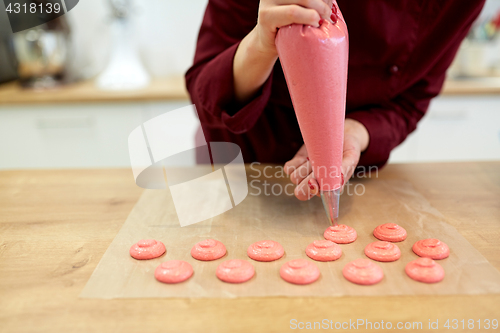 Image of chef with injector squeezing macaron batter