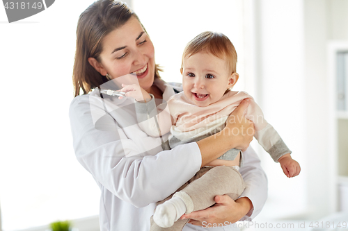 Image of doctor or pediatrician holding baby at clinic