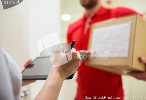 Image of customer with tablet pc signing for parcel