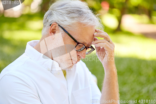 Image of thoughtful senior man at summer park