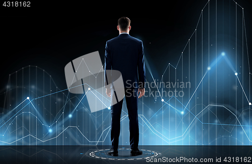 Image of businessman in suit from back with virtual graph