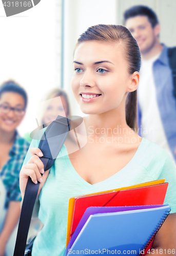 Image of student girl with school bag and color folders