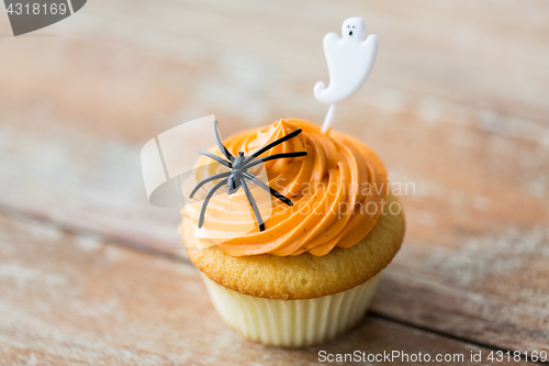 Image of cupcake with halloween decoration on table