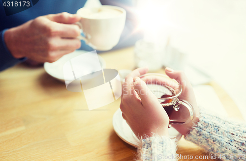 Image of close up of couple drinking tea at cafe