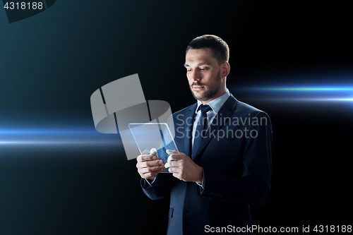 Image of businessman working with transparent tablet pc